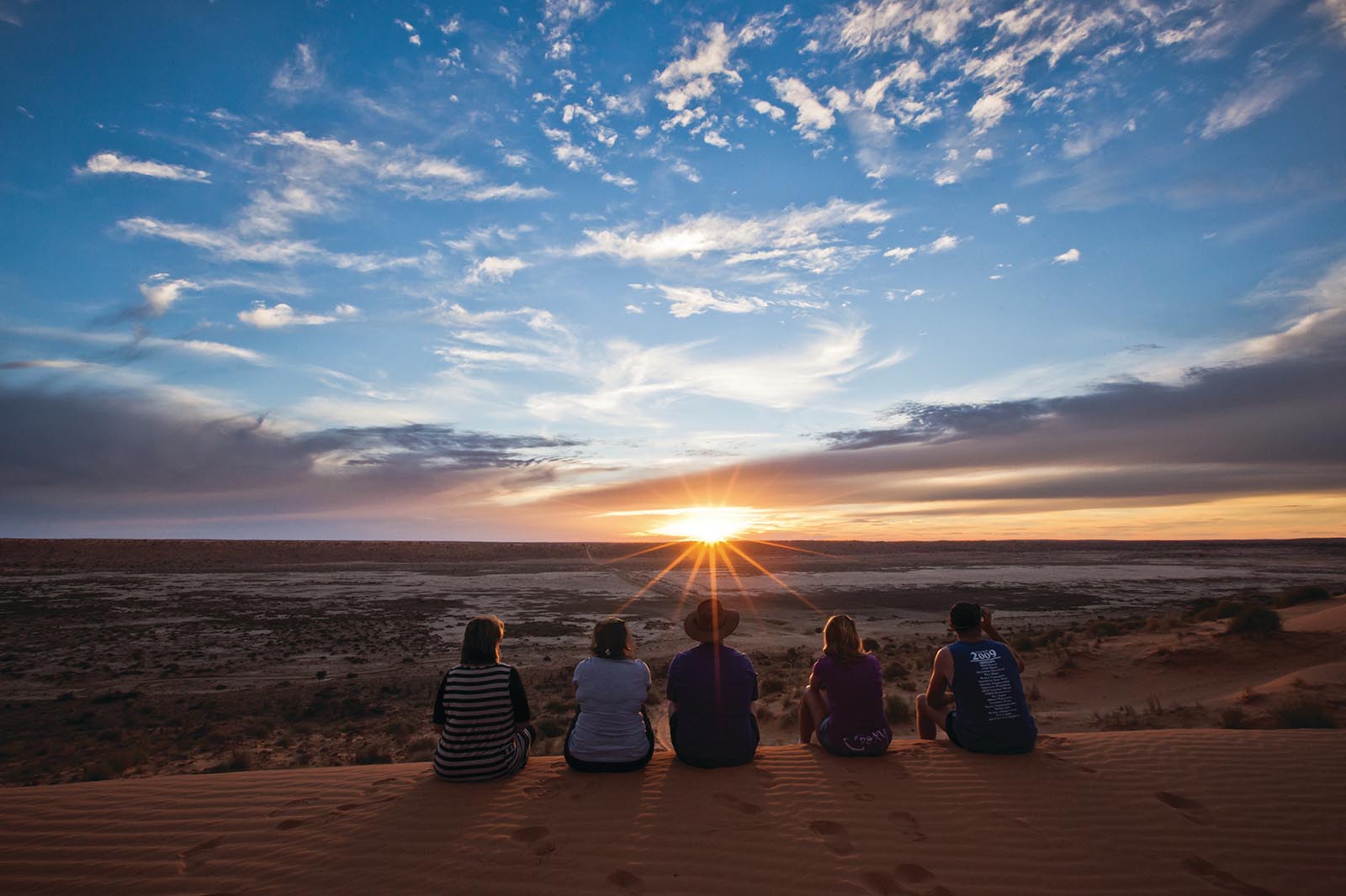 Group enjoying sunset at Big Red sand dune in the Simpson Desert | A bird's eye view of Birdsville