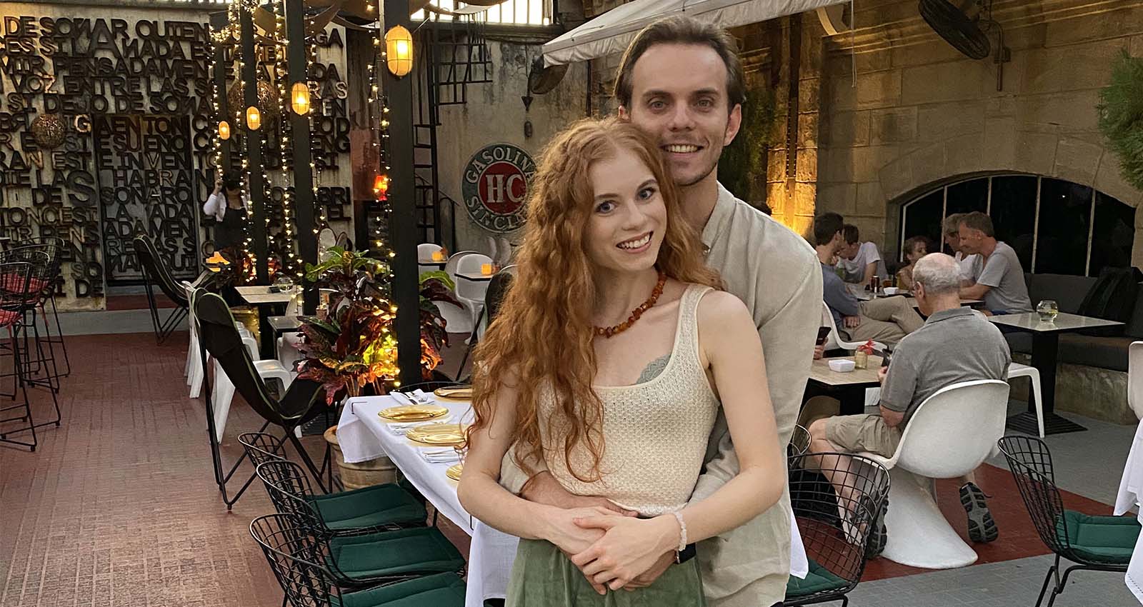 A man and a woman pose for a photo in a restaurant