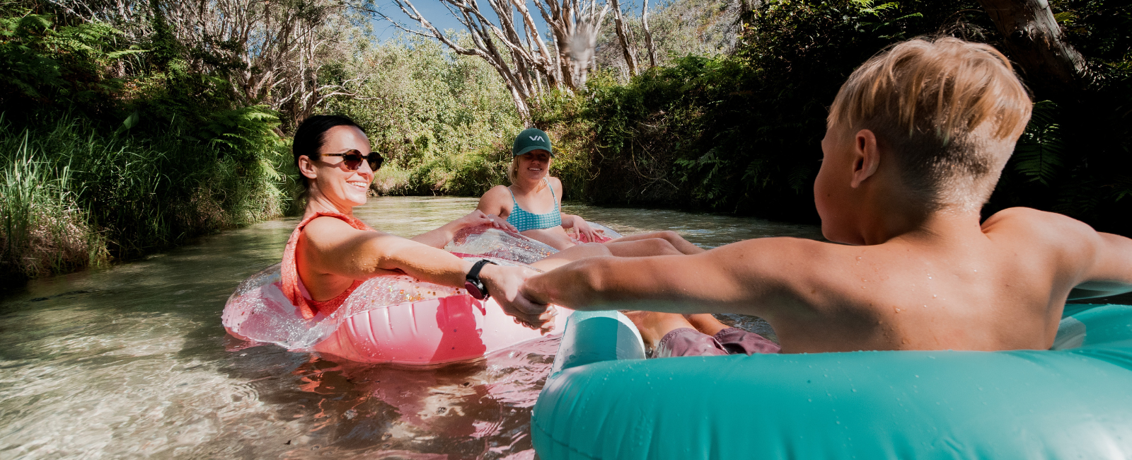 People floating down Eli Creek on pool toys