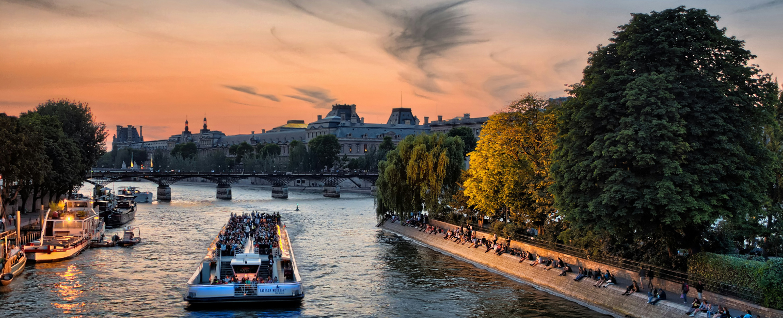 Boat touring along the Seine at sunset