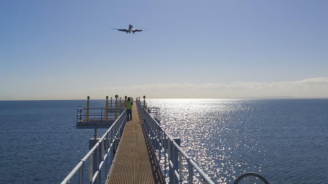 HIAL Jetty with plane overhead at Brisbane Airport HIAL Jetty with plane overhead at Brisbane Airport